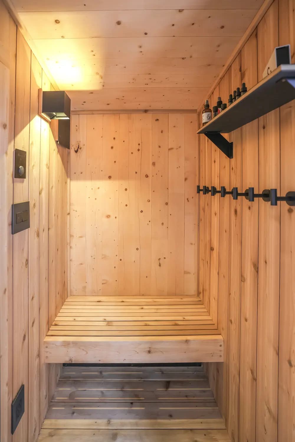 Cedar and Stone sauna interior with aromatherapy shelf and warm lighting