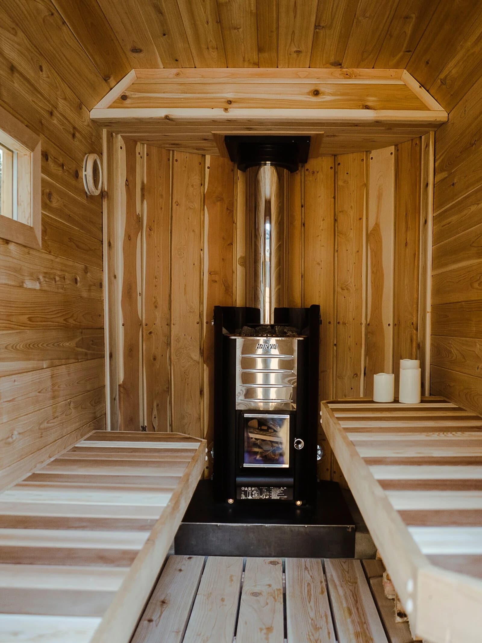 Gather Sauna House interior with wood-burning stove and cedar benches
