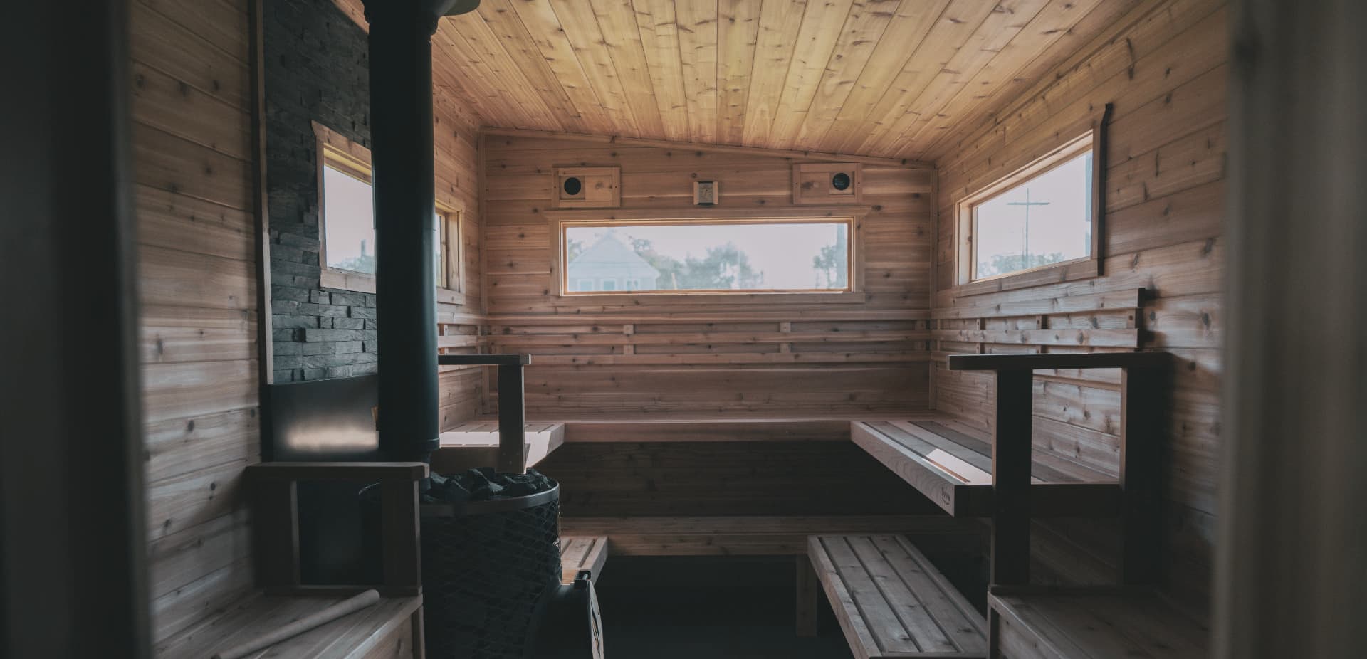 Hearth Sauna at Mt. Holiday with wood-fired sauna and northern Michigan forest backdrop