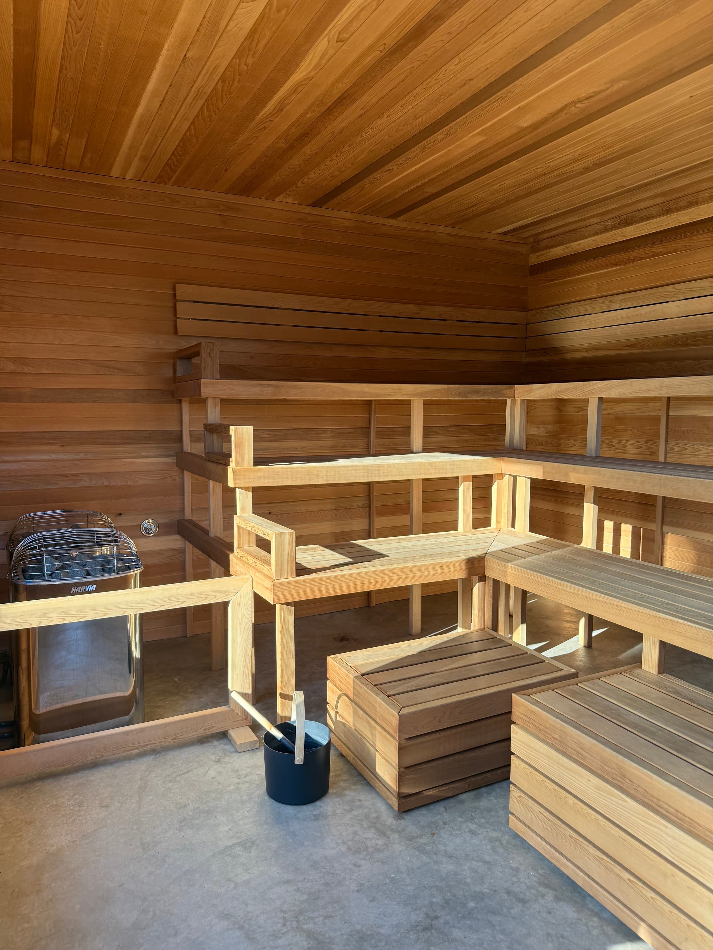 Koti Sauna cedar interior with tiered benches and heater