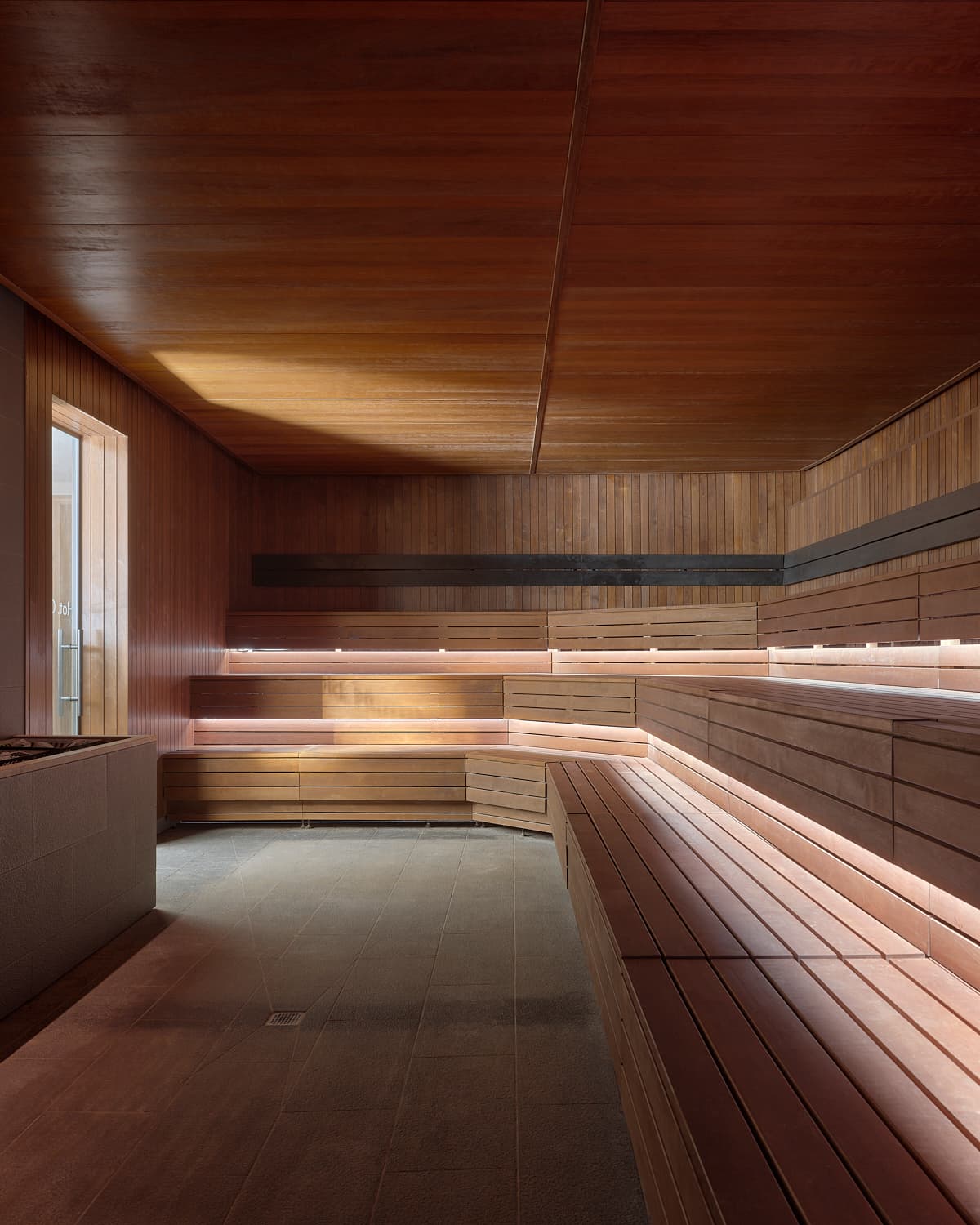 Lore Bathing Club sauna with curved wood ceiling and LED lighting