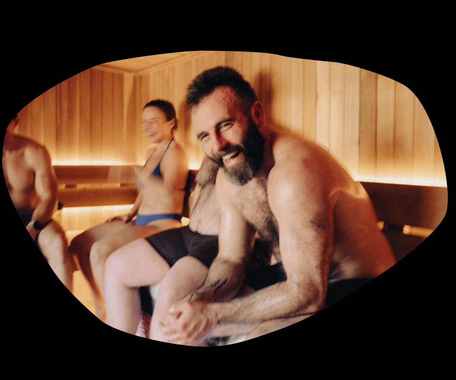 People laughing together inside the Lost Language communal sauna