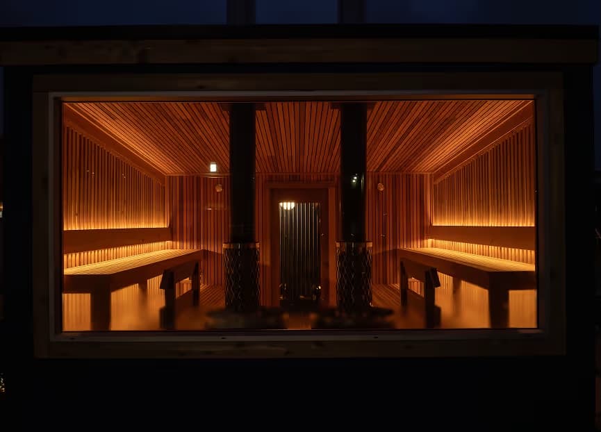 Seattle Sauna cedar-lined interior viewed through window at night