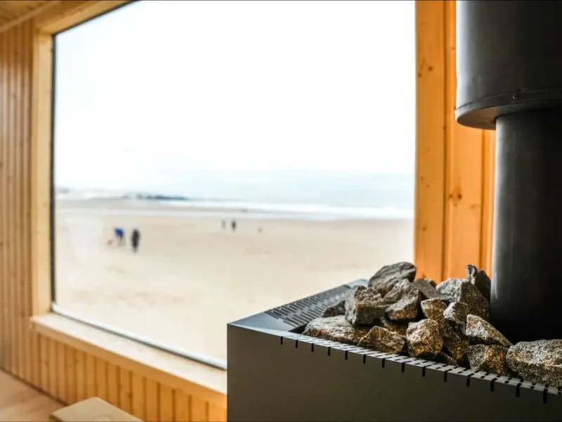 Wood-fired sauna heater with panoramic beach view at Steam and Salt, Tynemouth