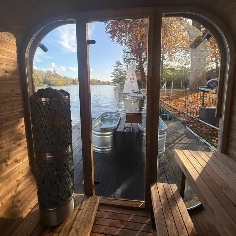 Inside the TEMZ floating sauna with heater, ice bath on the pontoon, and Thames river views