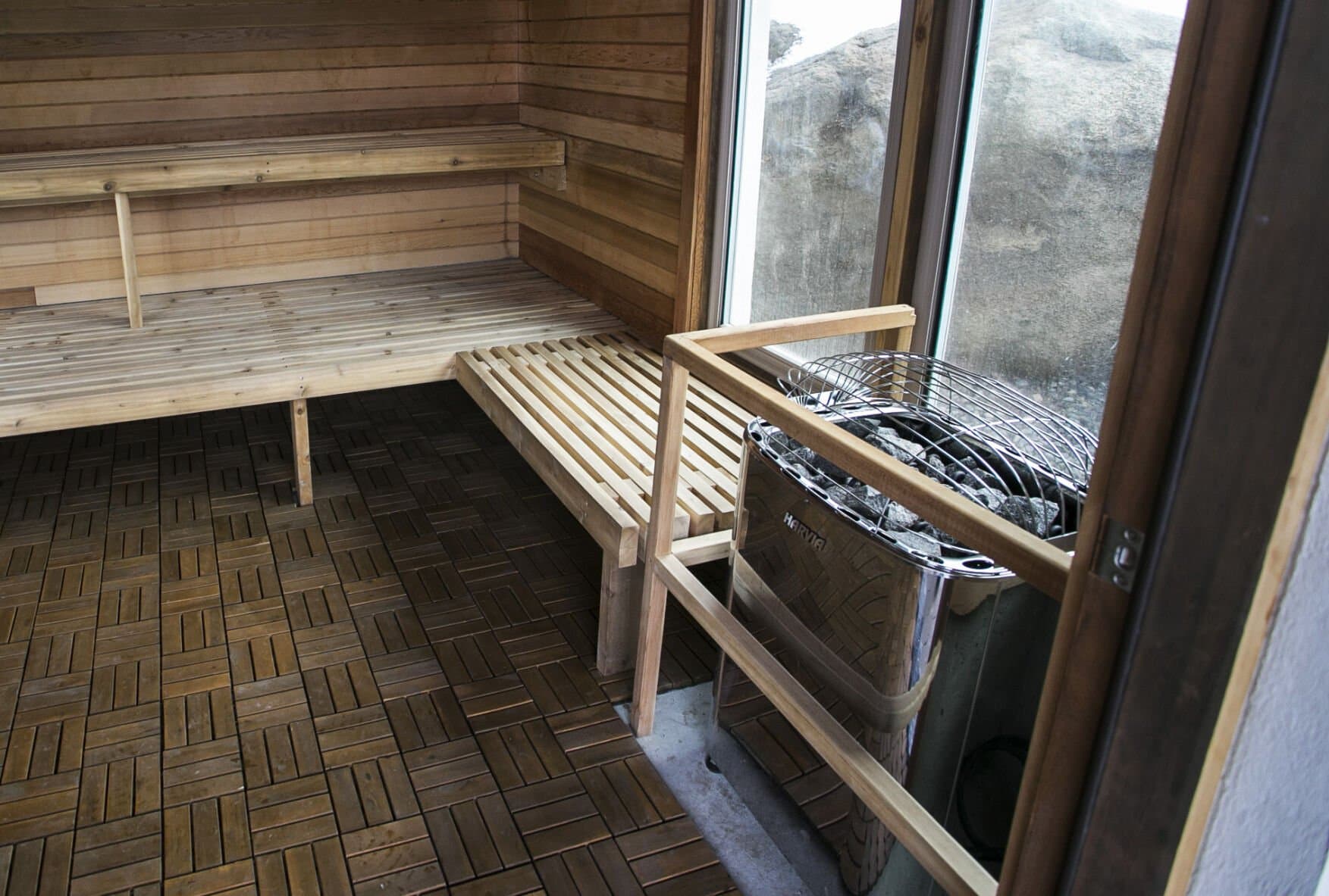 The Springs cedar sauna interior with wooden benches and heater