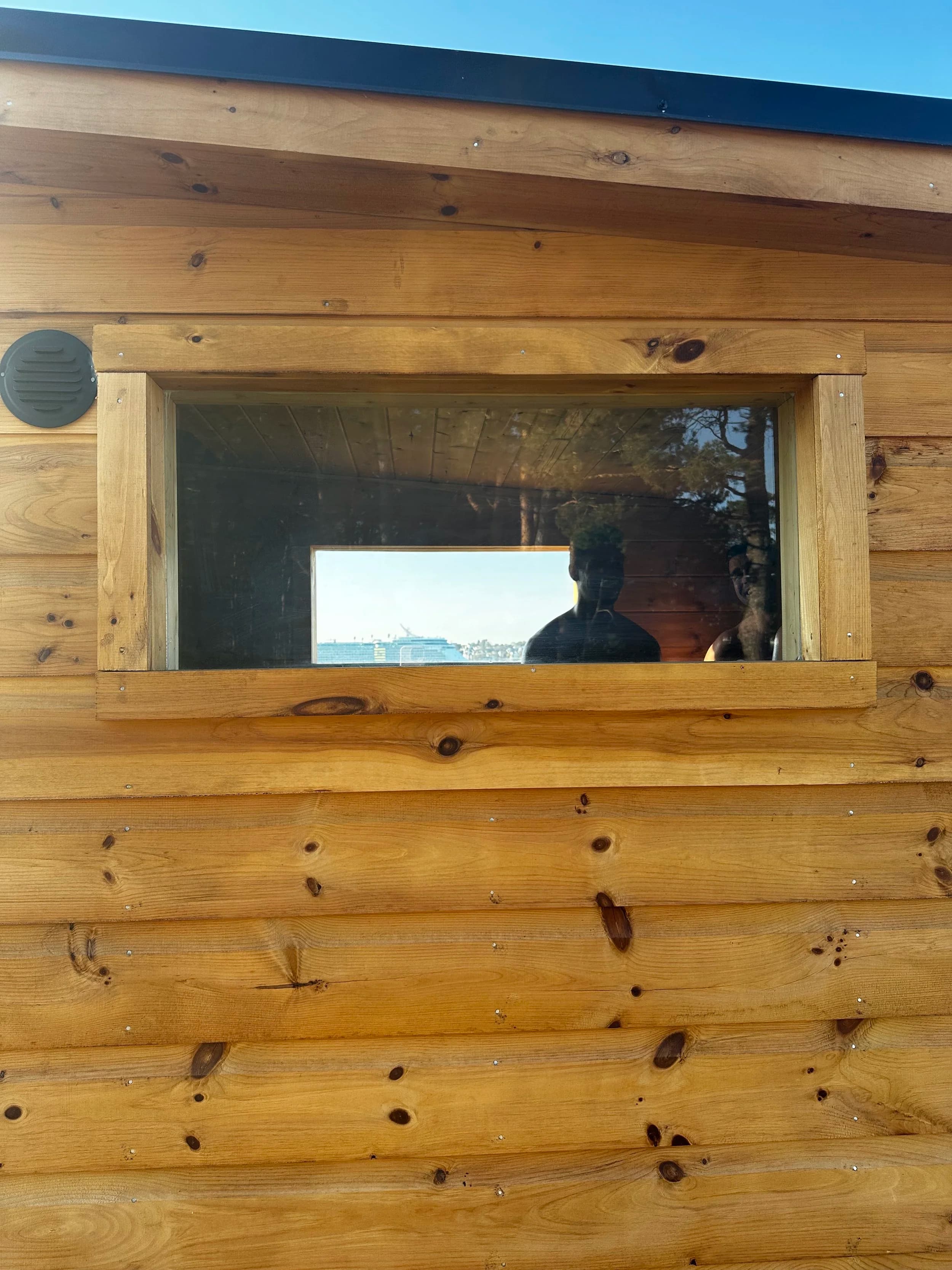 Village Sauna wood-fired mobile sauna exterior with view through window