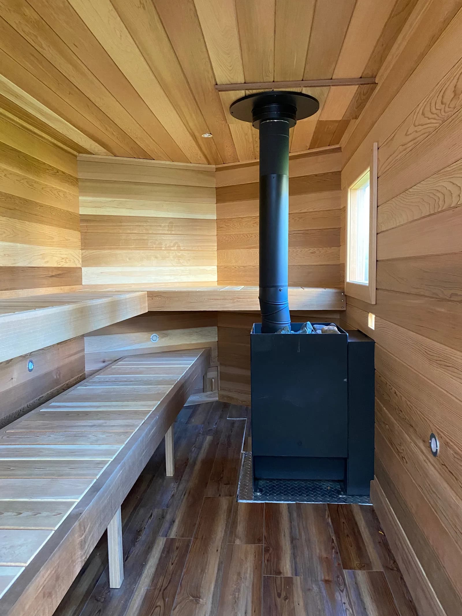 Cedar interior and wood stove of the Artisan Portable Saunas trailer