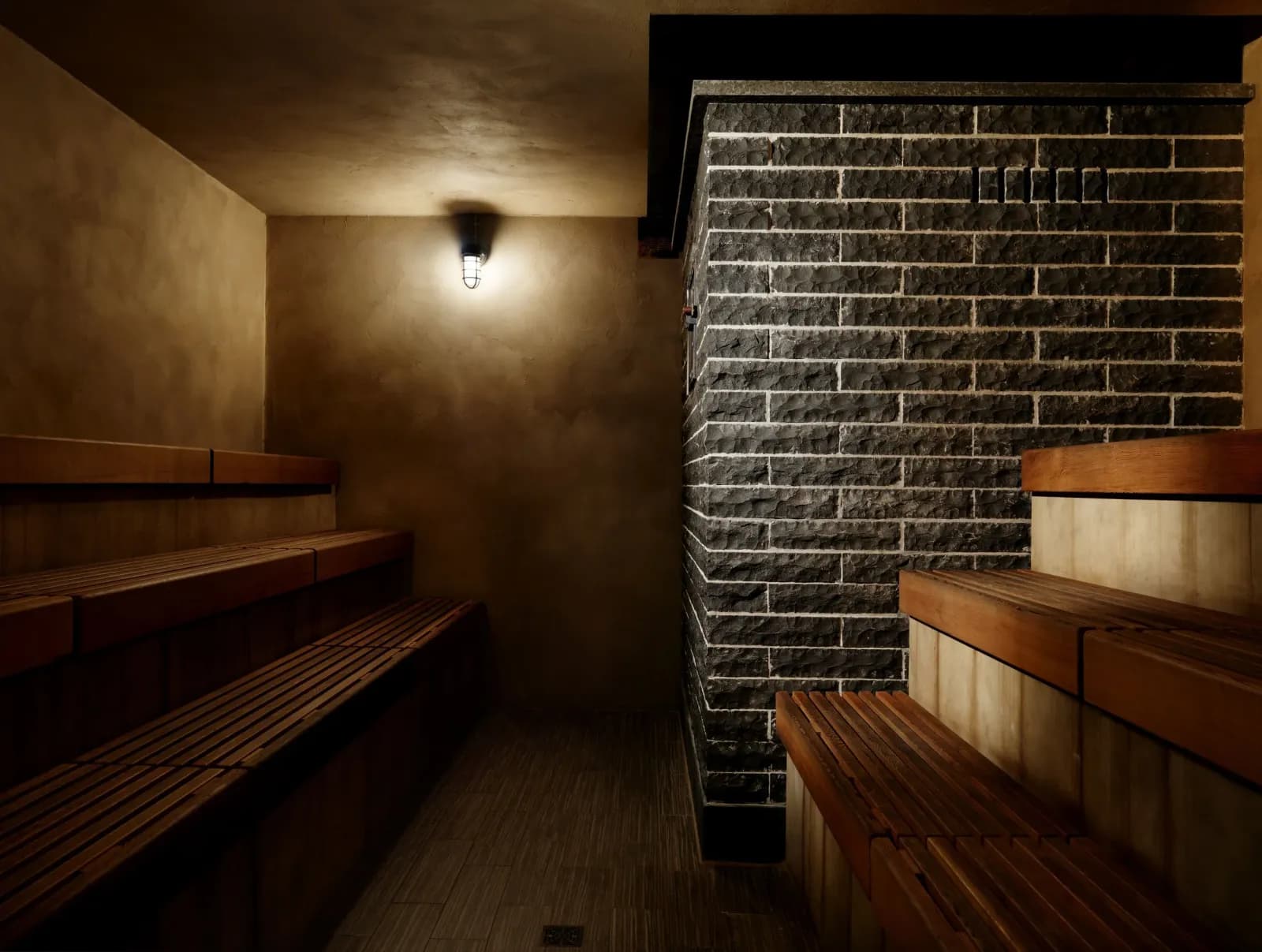 Wood-lined parilka (Russian sauna) with brick stove at Banya 5, Seattle