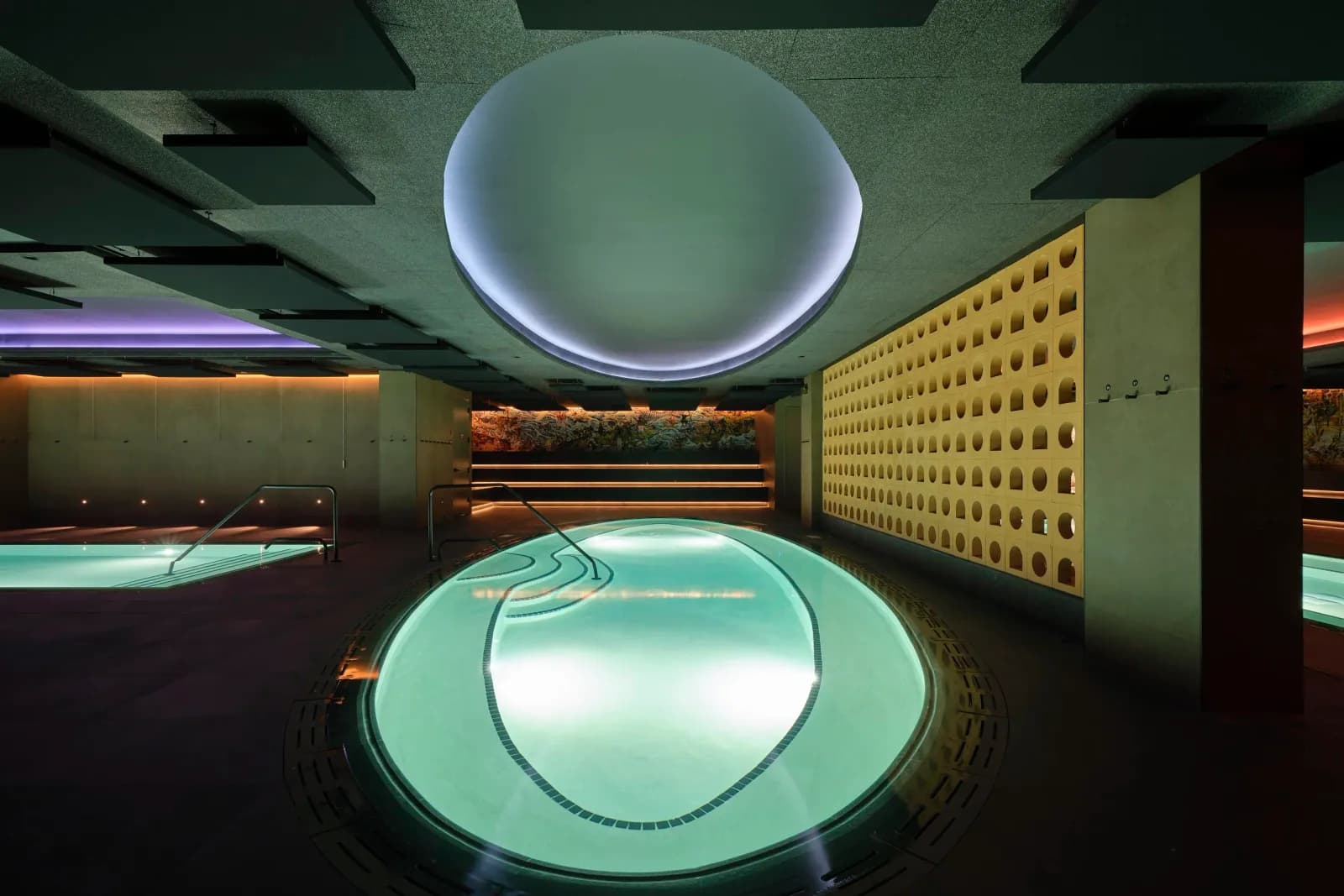 Oval thermal pool under a round skylight at Bathhouse Atlantic Ave