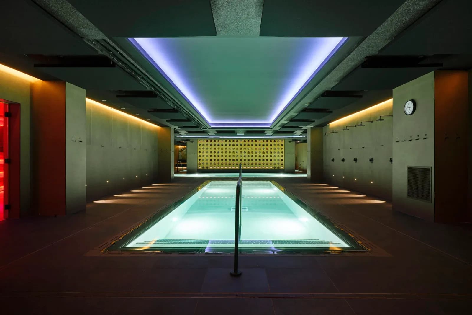 Thermal pool hall with red-lit sauna doorway at Bathhouse Atlantic Ave