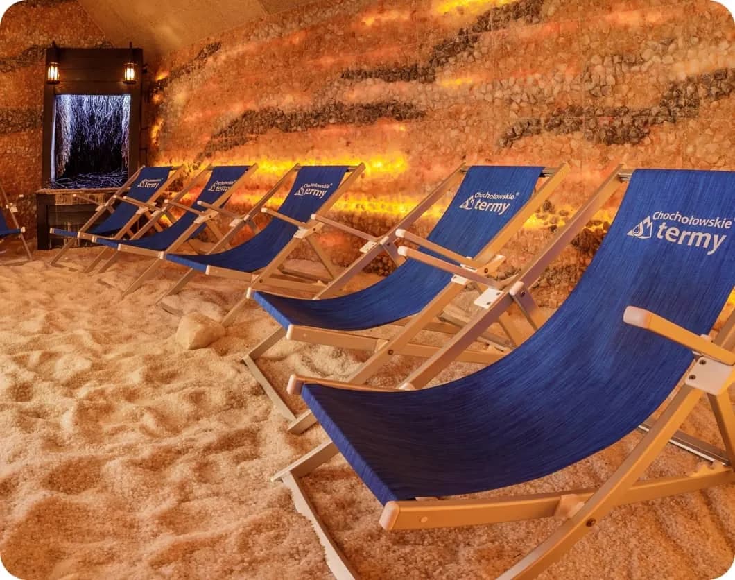 Salt cave relaxation area at Chochołowskie Termy with branded deck chairs and illuminated salt walls