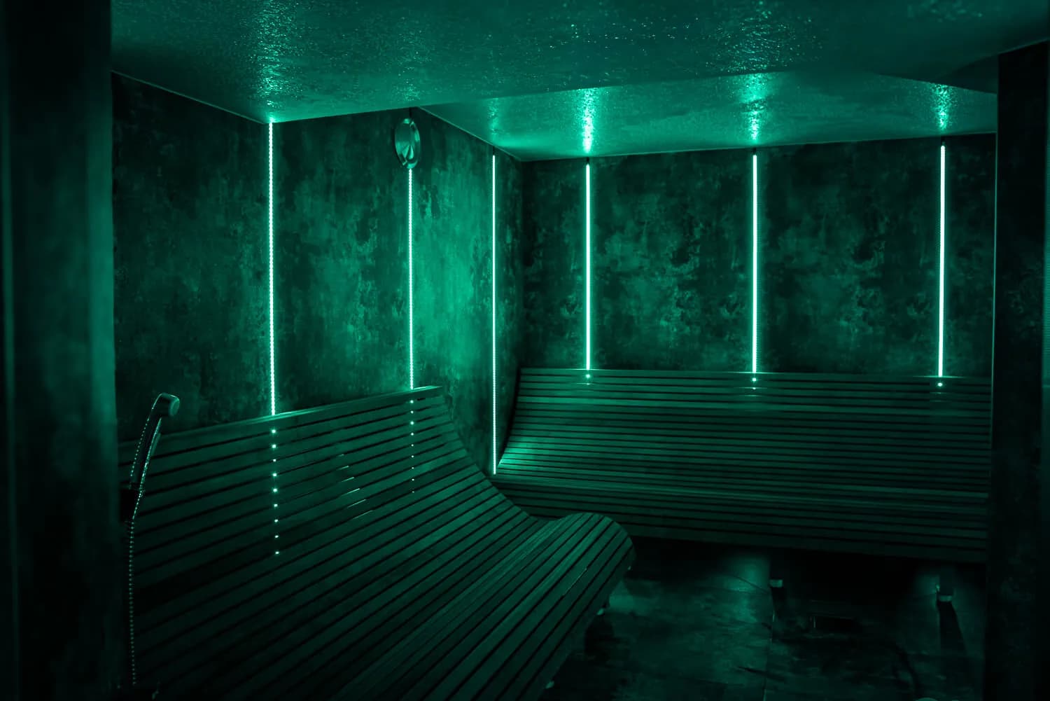 Atmospheric steam room at Chochołowskie Termy with green LED lighting and wooden benches
