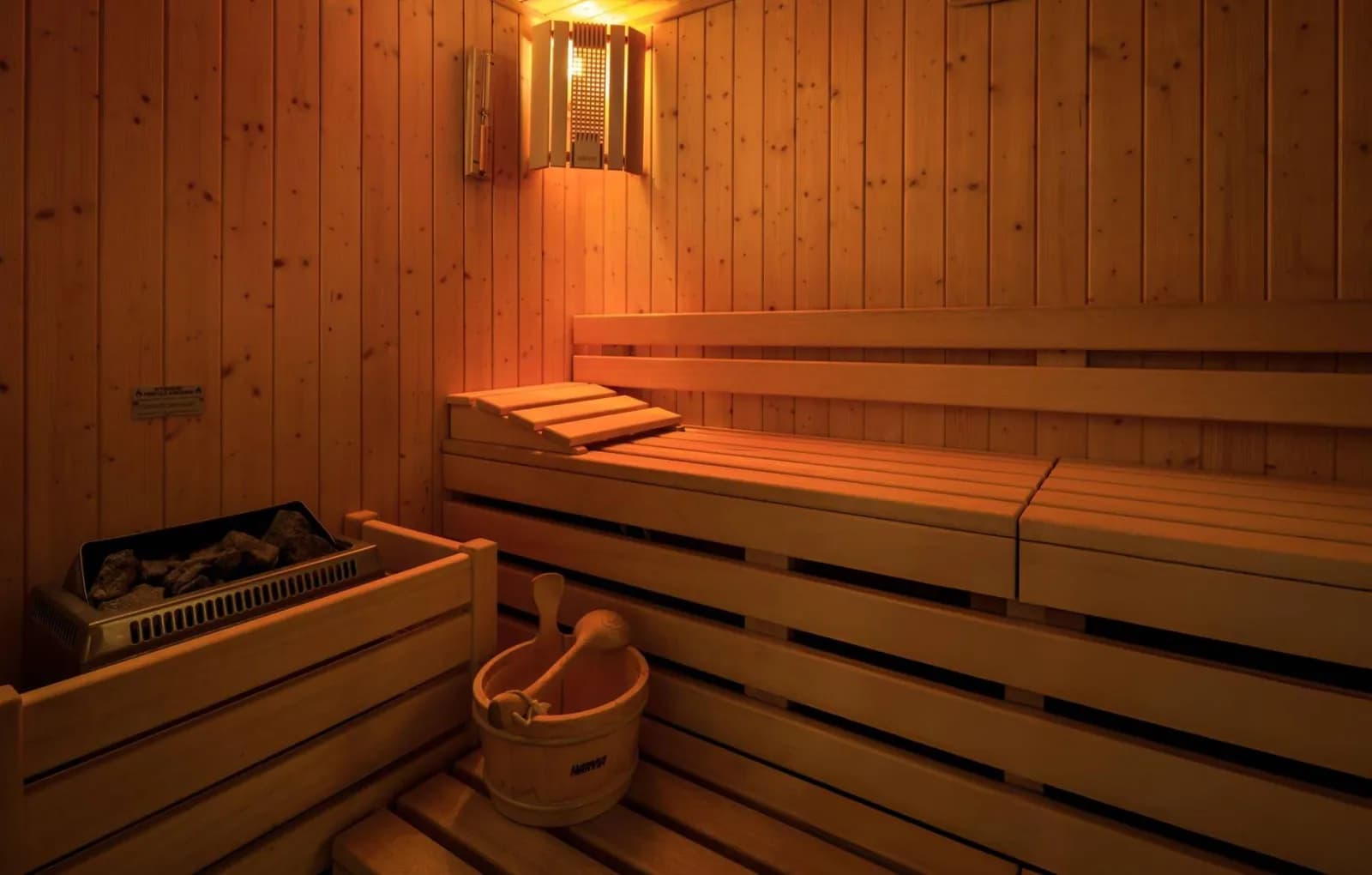 Interior of the Driftwood Sauna Club with wooden benches and heater