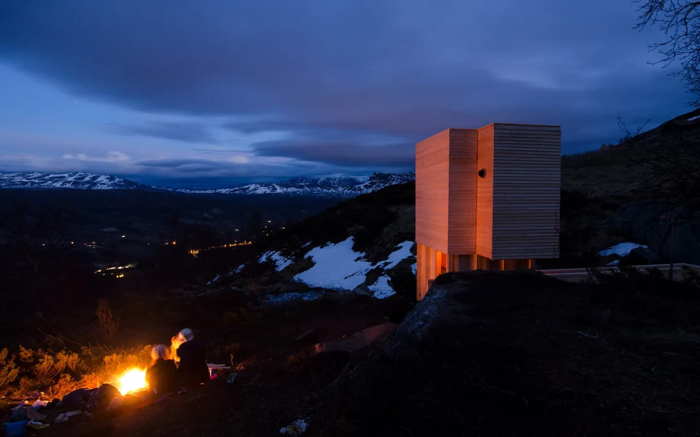 Eldmølla sauna building glowing at dusk above the Vang valley