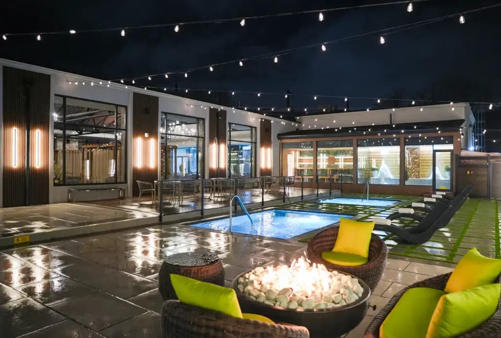 Outdoor thermal pools, fire pit seating, and relaxation loungers at Fusion Spa & Resort