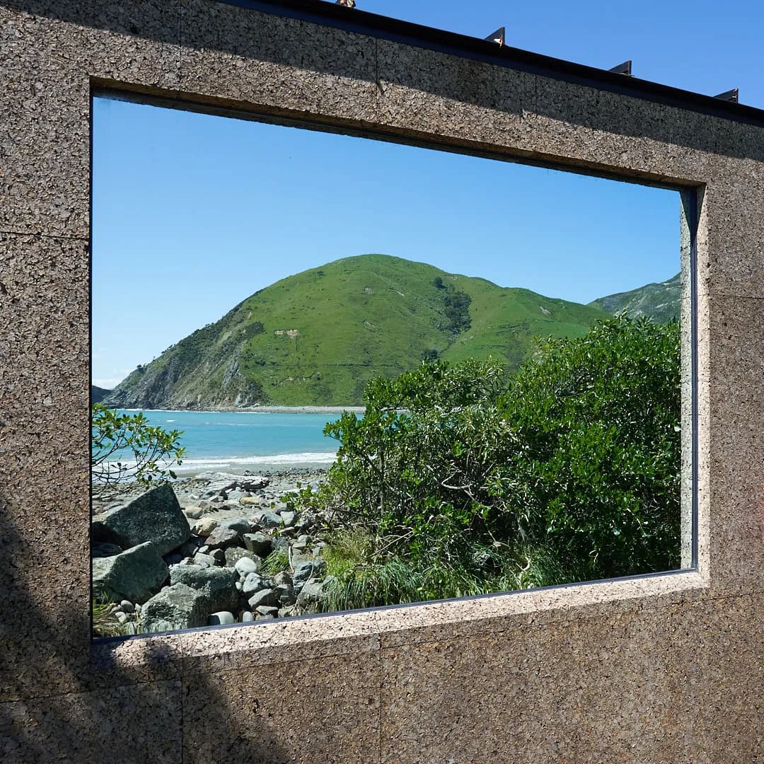 Goodheat Sauna reflected in water at Cable Bay beach, Nelson, New Zealand