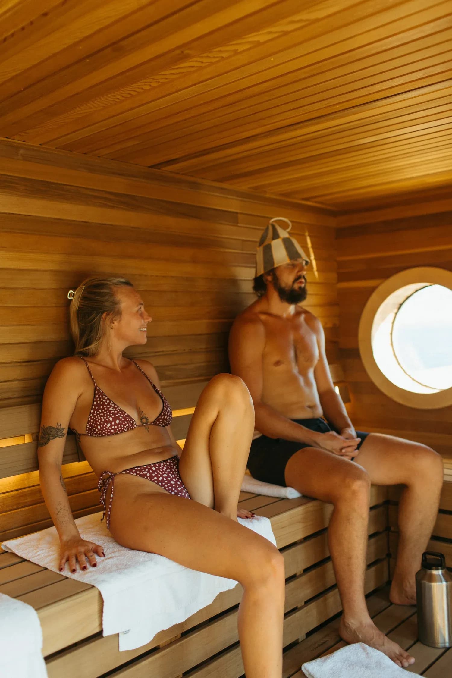 Kiln Floating Sauna cedar interior with porthole window on Lake Michigan