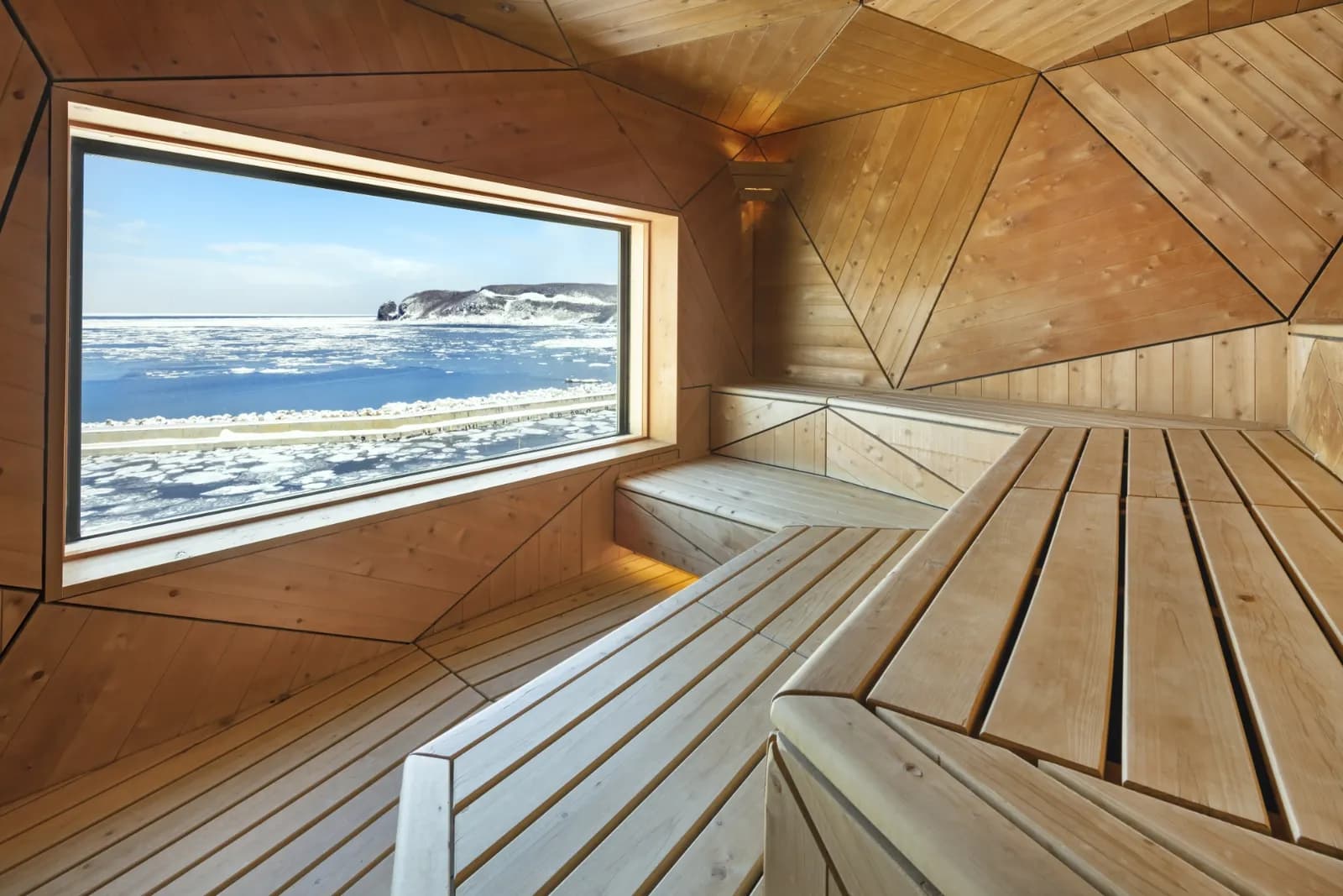 KAKUUNA sauna at Kitakobushi Shiretoko with panoramic window overlooking drift ice on the Sea of Okhotsk