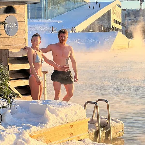 KOK Oslo floating sauna on the fjord with the Oslo Opera House in the background