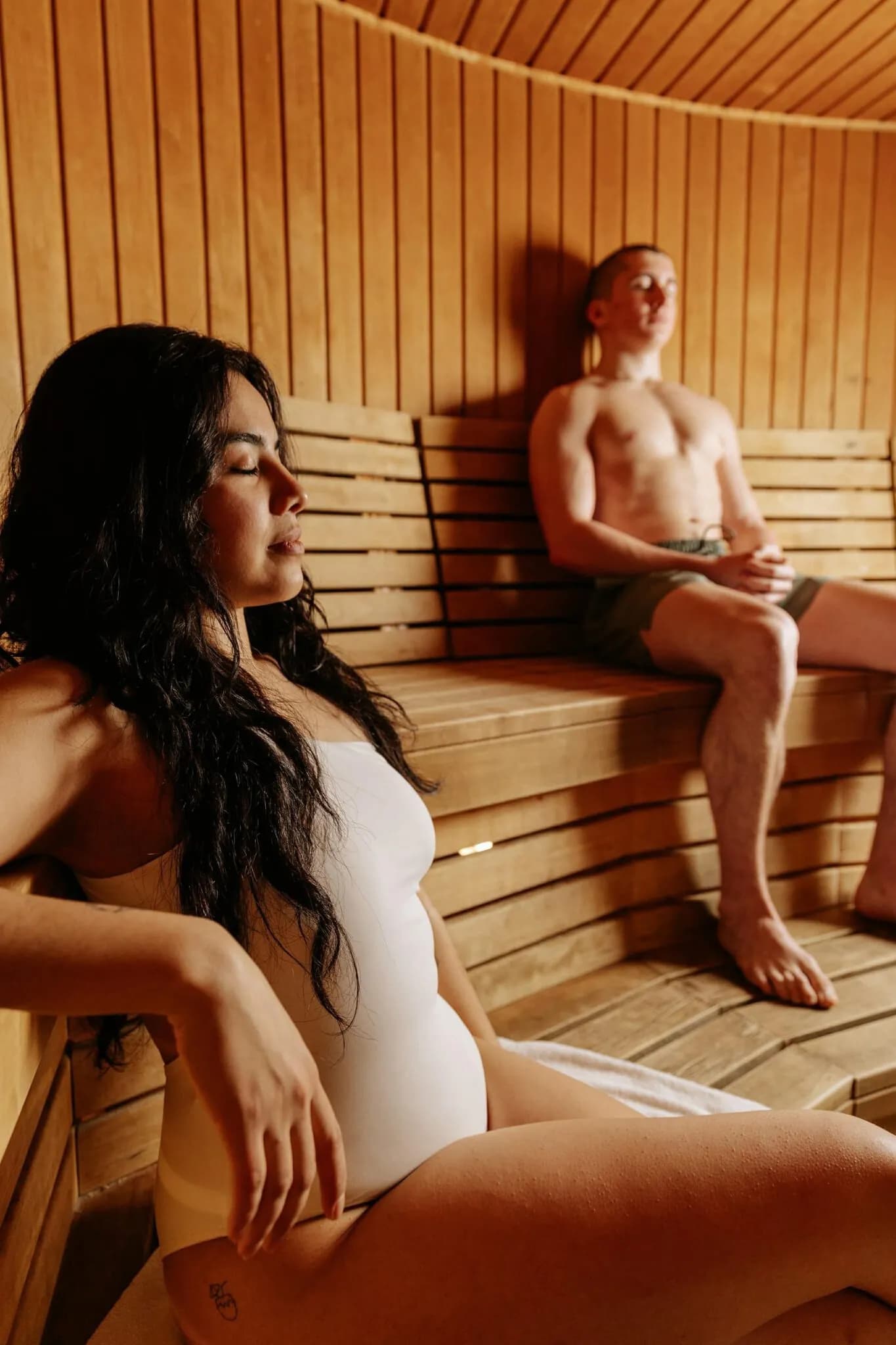 Two guests in the cedar-lined Finnish sauna at L'Absolu Spa