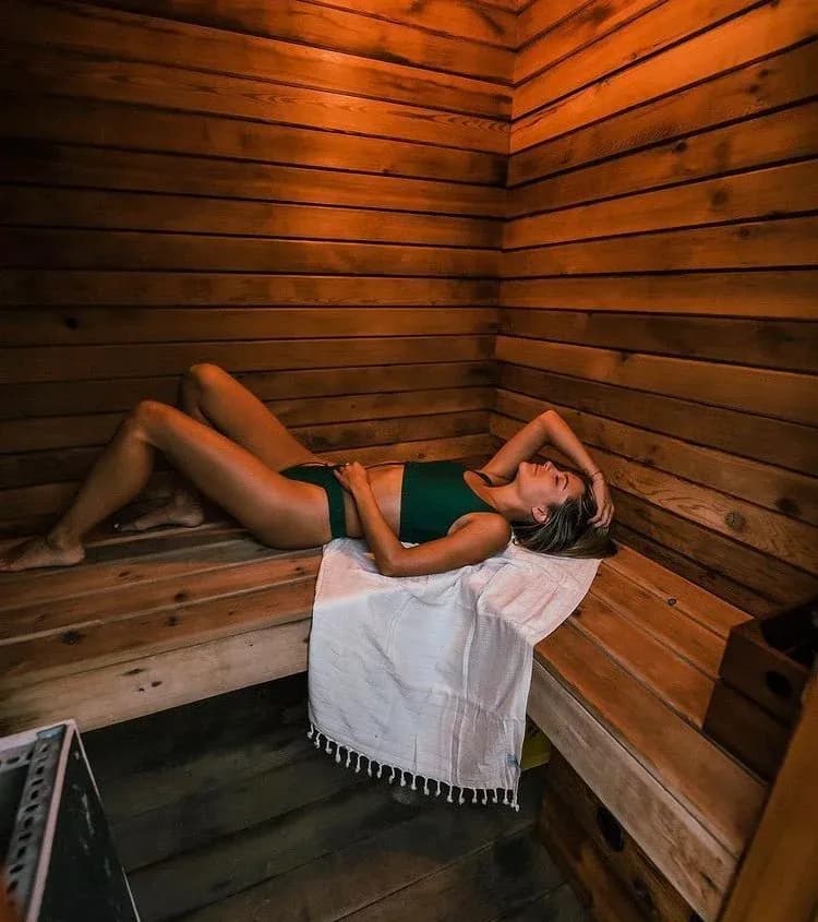 Interior of the cedar wood-fired sauna at Lagoon Float Camp with bench seating