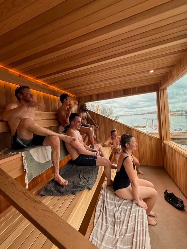 Guests enjoying a community sauna session aboard Löyly Floating Sauna