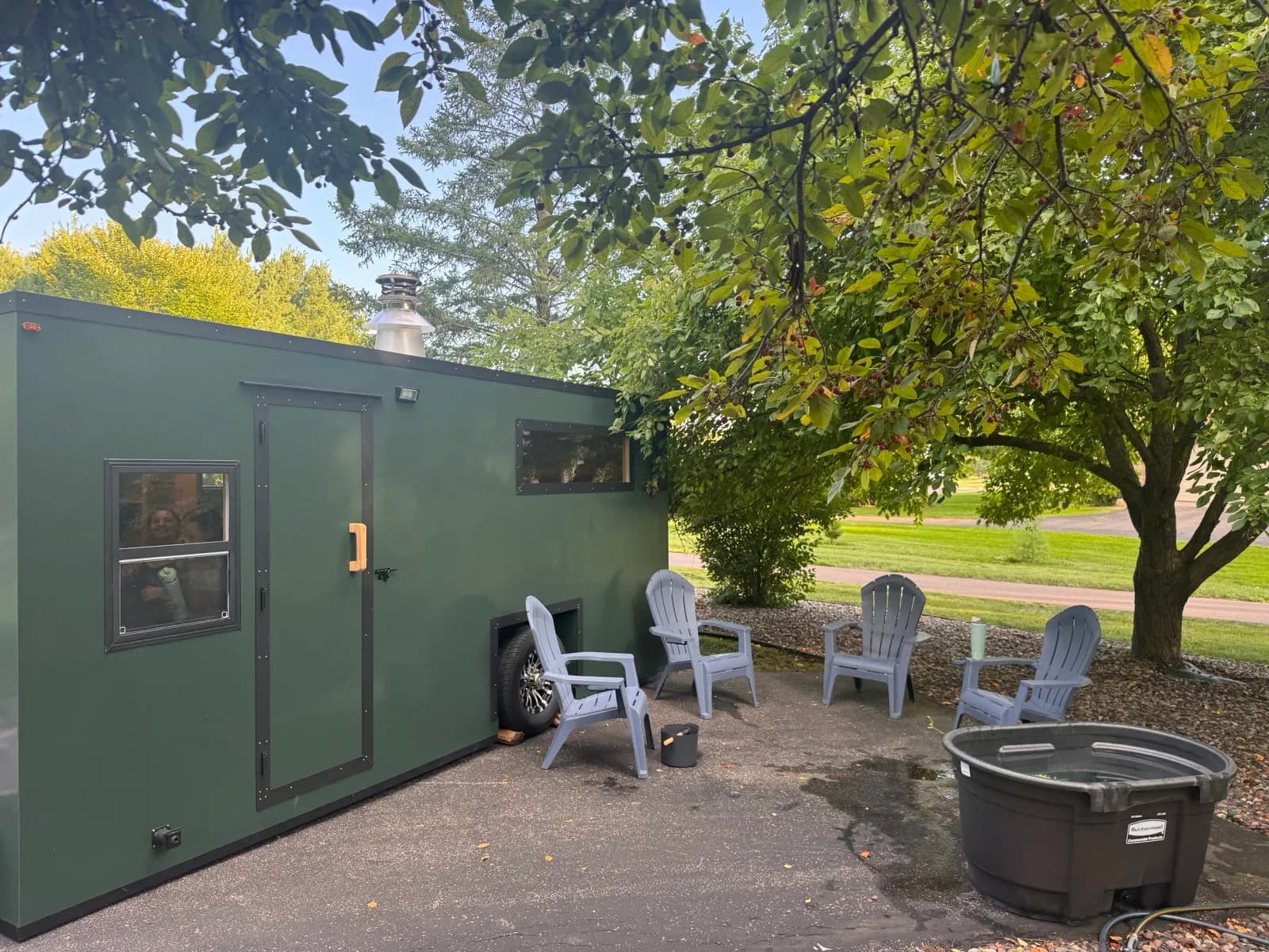 Nordic Renewal sauna setup with Adirondack chairs and cold plunge barrel