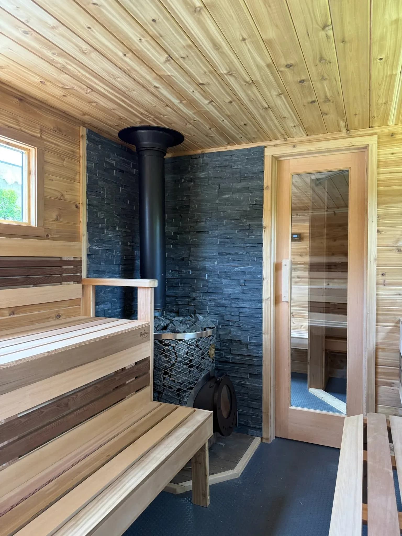 Interior of Nordic Renewal sauna with wooden benches and wood stove