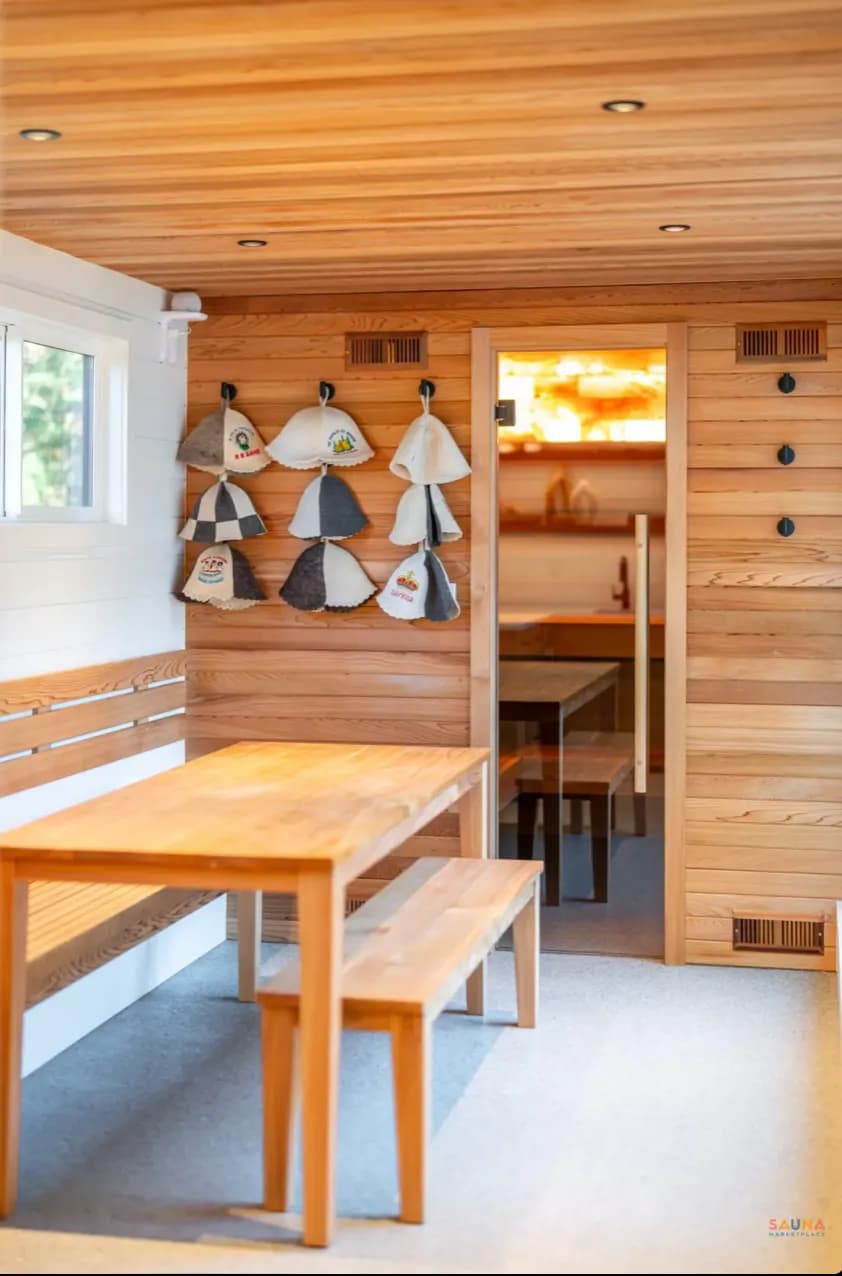 Warm wooden lounge interior at Nordica Haus with benches and soft lighting