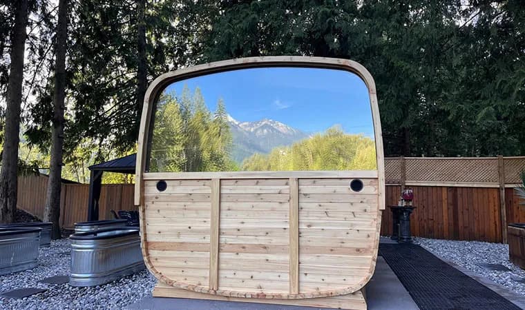 Wood-fired barrel sauna with mountain views and cold plunge tubs at Poseidon's