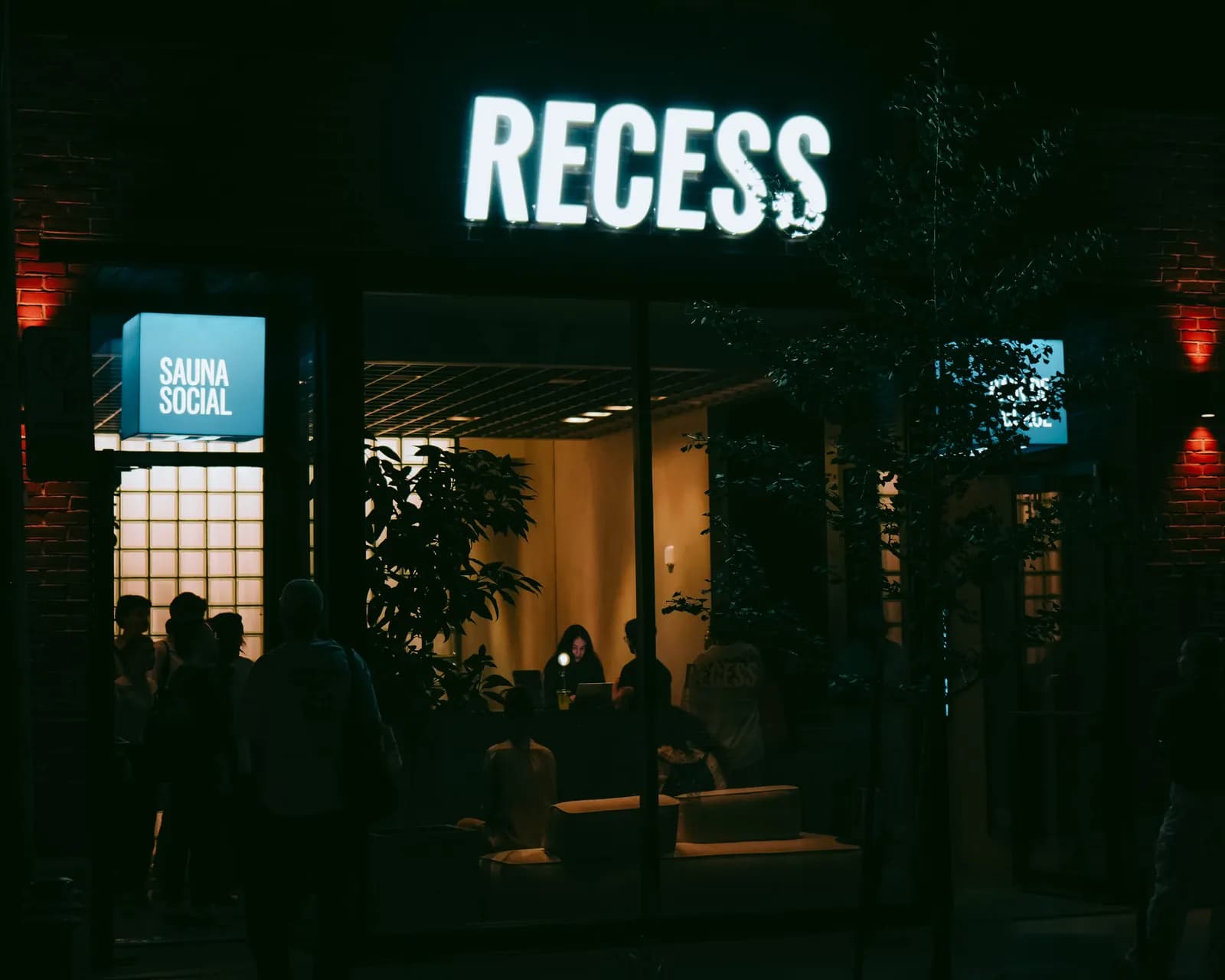 RECESS exterior at night showing SAUNA SOCIAL signage in Griffintown, Montreal