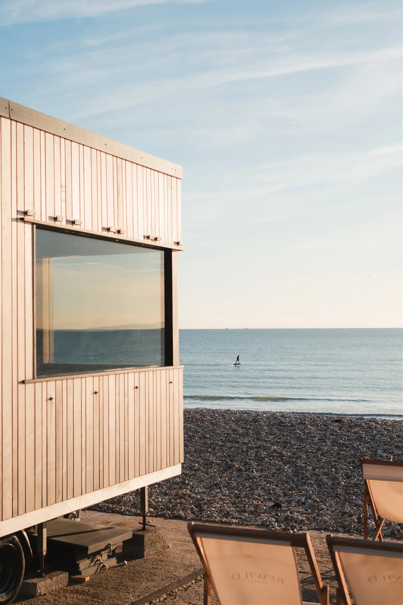 Rewild Sauna building overlooking the beach and sea