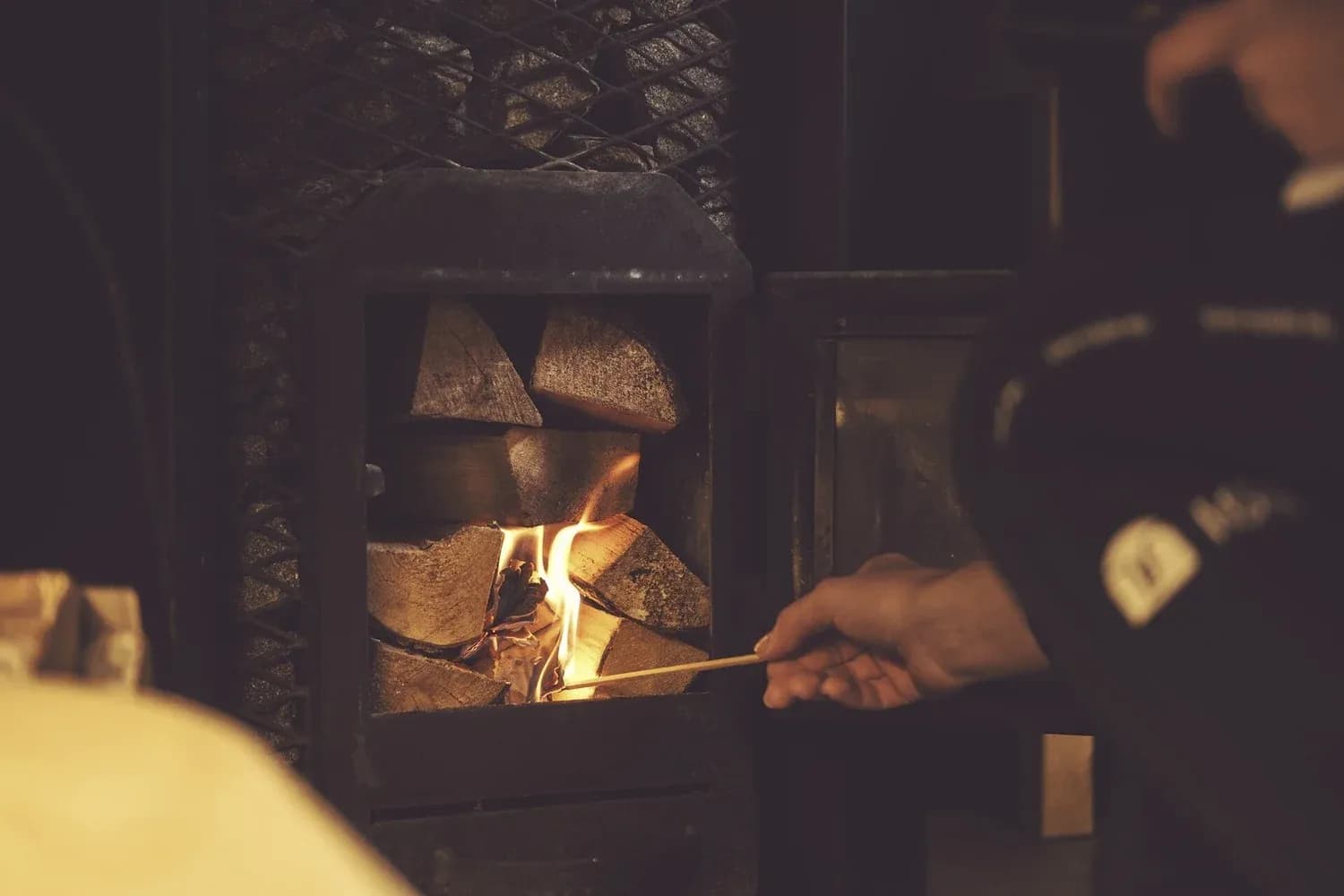 Wood-fired sauna stove being lit at Riverwalk Saunas