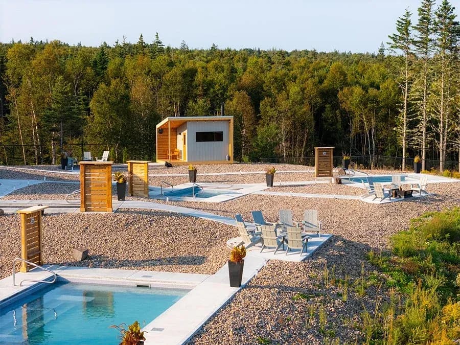 Saltair Nordic Spa outdoor landscape with sauna structures along the Bay of Fundy coast