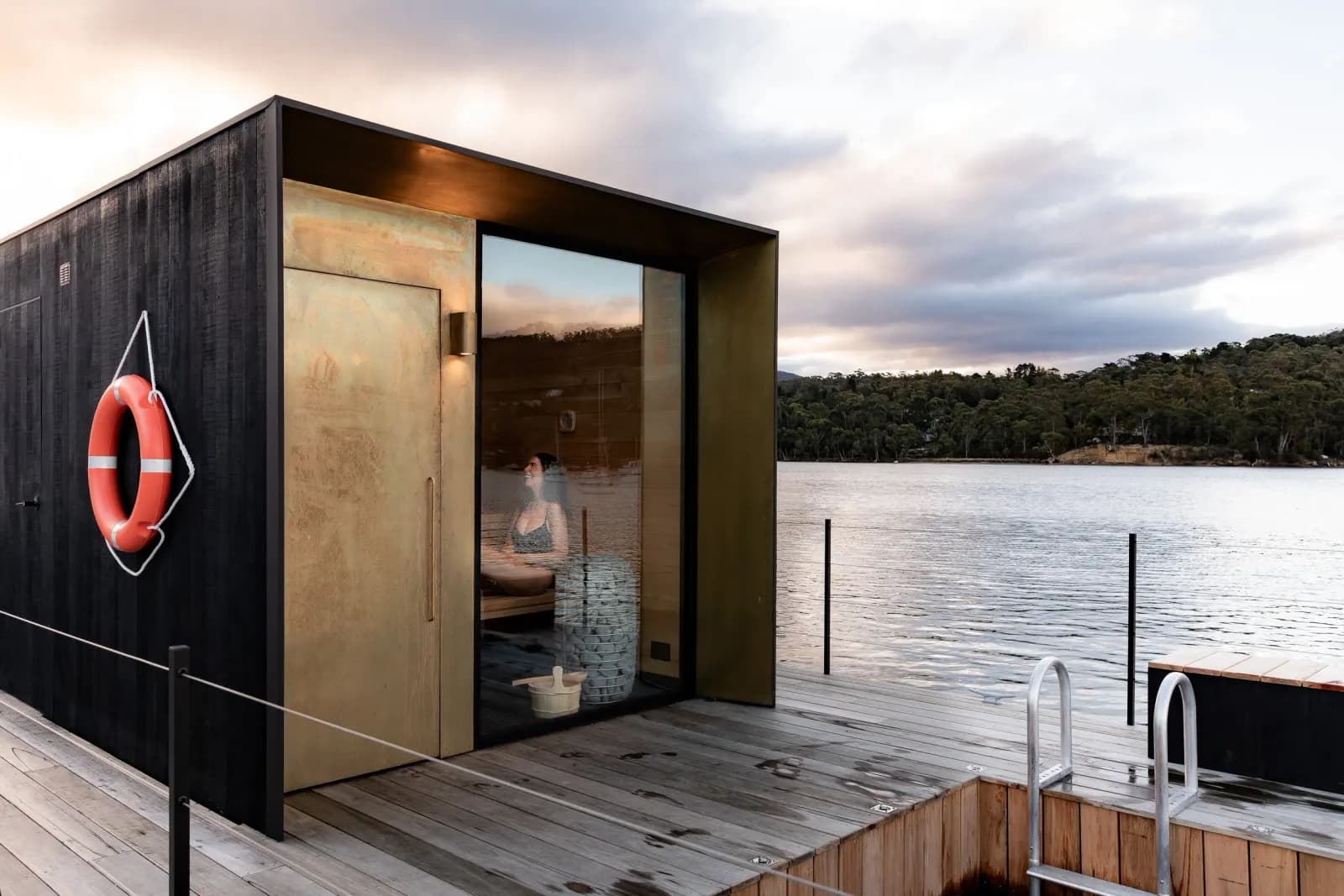Interior of Sauna Boat Tasmania with view of Little Oyster Cove through glass doors