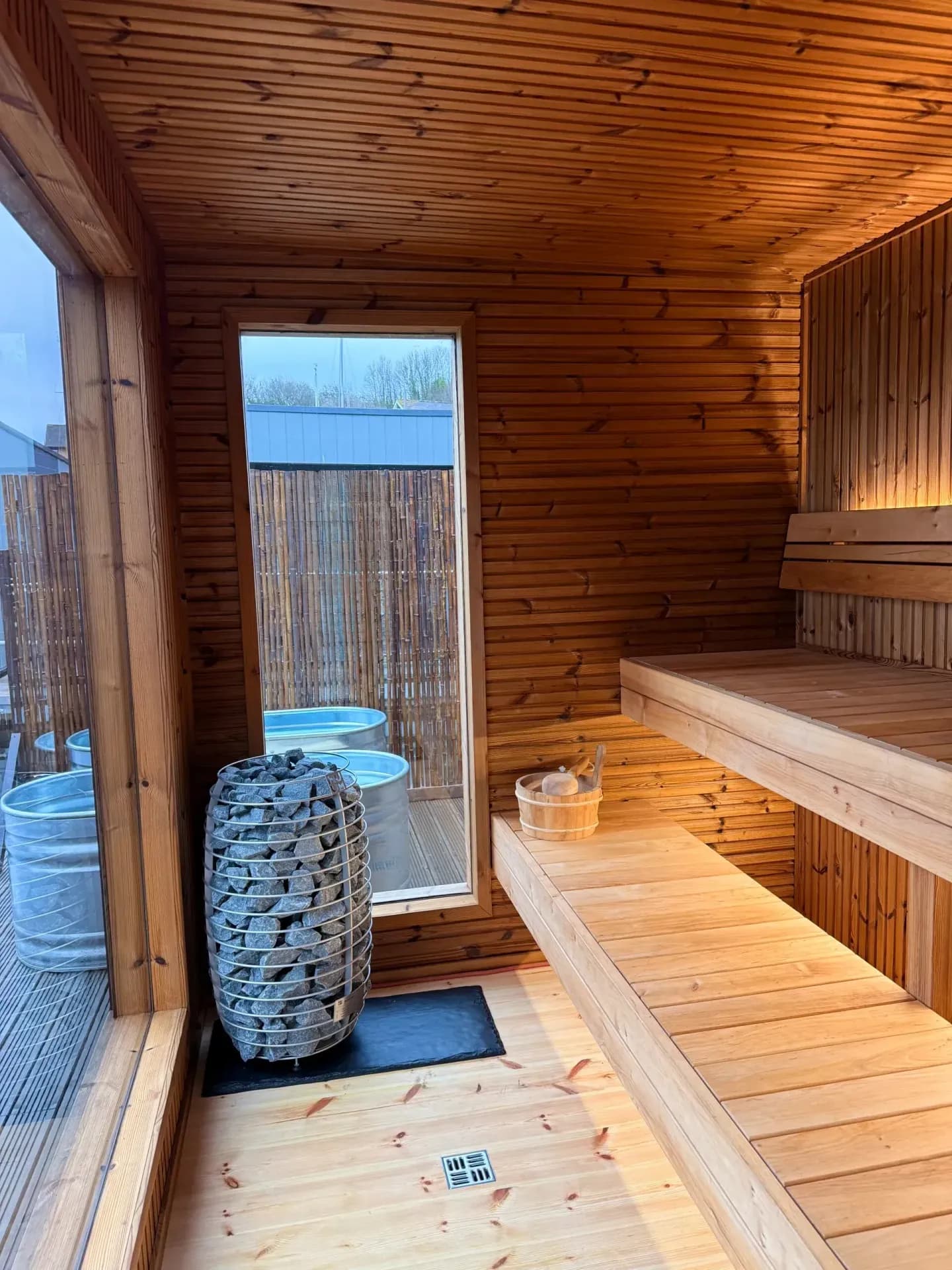Sauna Flô interior with wood-lined benches and HUUM electric heater at Penarth Marina