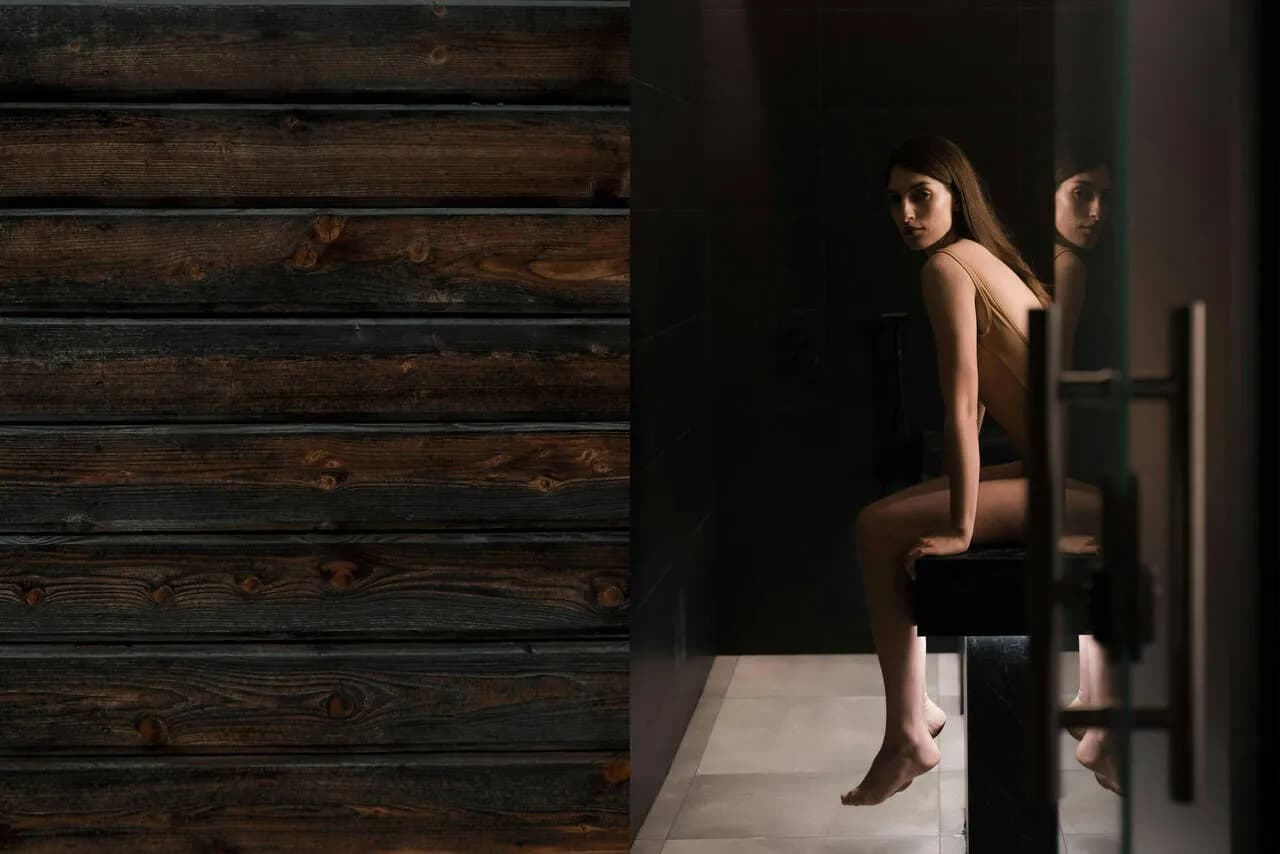 Private sauna suite with charred-wood sauna and tiled cold plunge area at Sauna Suomi
