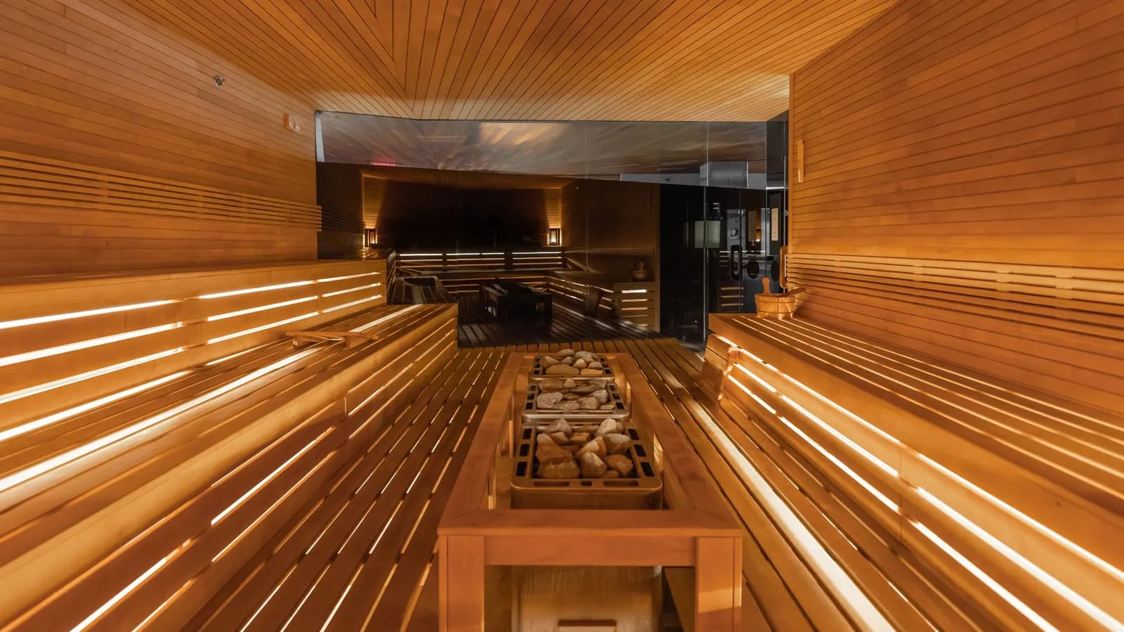 Wood-lined dry sauna with tiered benches at Scandinave Spa Vieux-Montréal