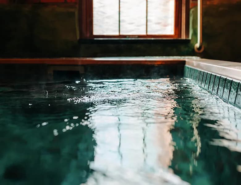 Private salt-water soaking tub with steam rising