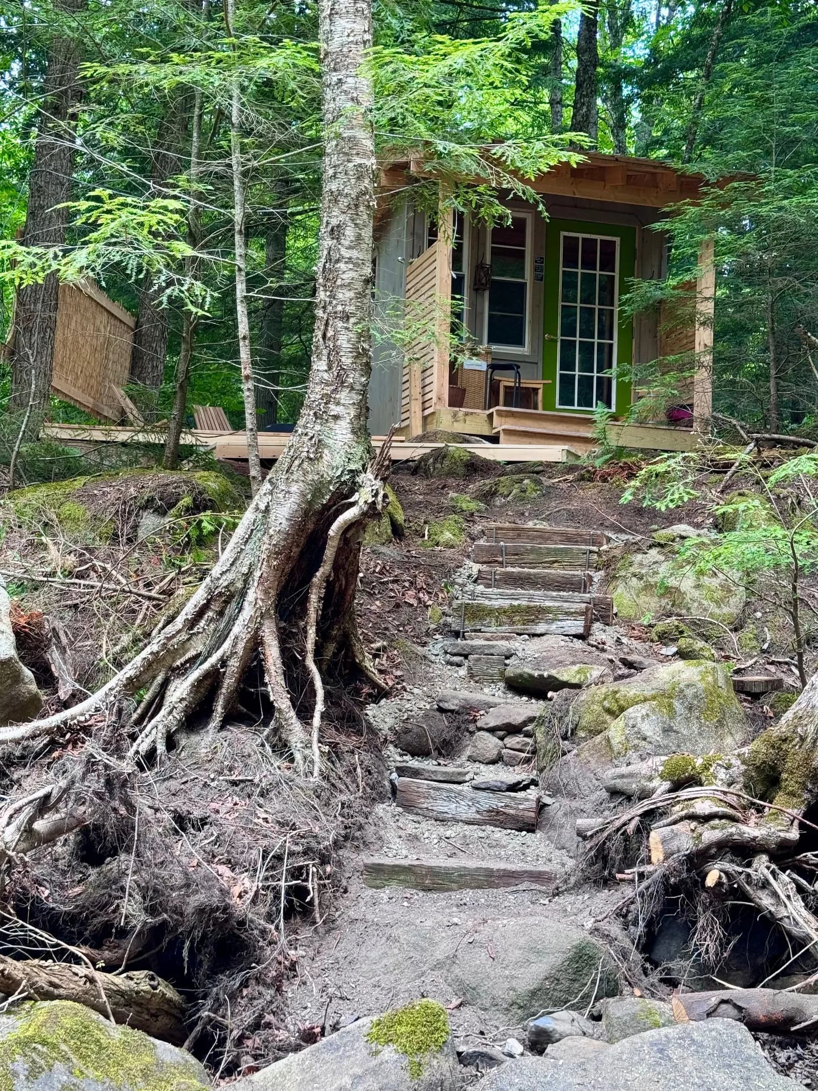 Stone City Forest Spa sauna building beside the stream in the Vermont woods