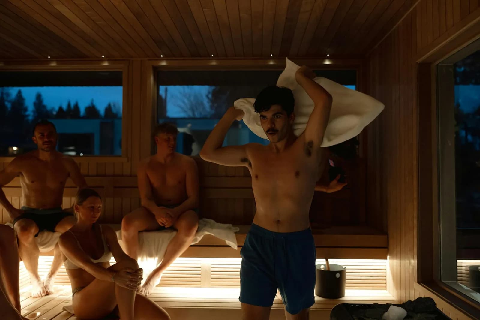 Aufguss session in Symmetry Sauna Studio communal sauna with lake views at dusk