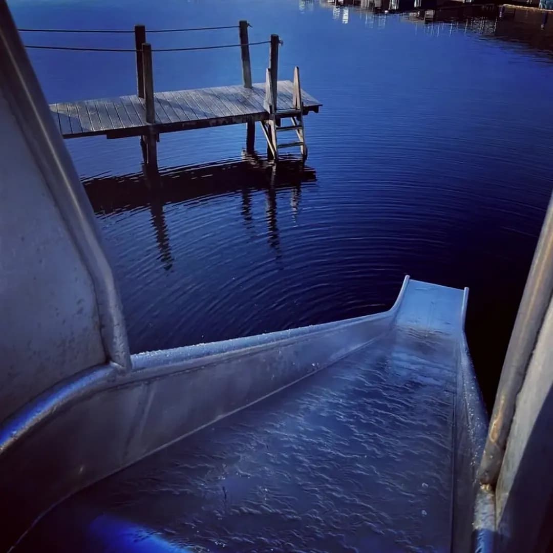 Water slide into Loch Tay for cold plunges at Taymouth Marina HotBox Spa with jetty and Highland views