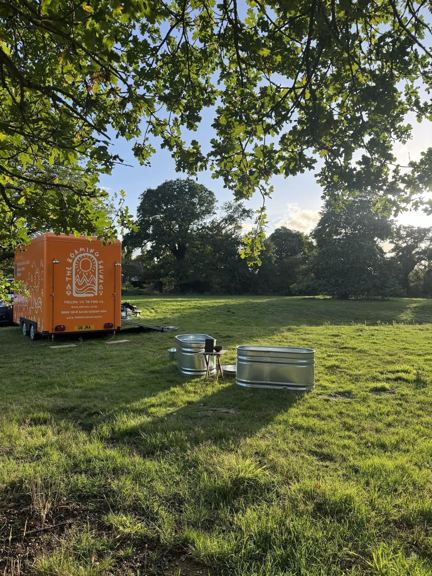 The Roaming Sauna mobile sauna with cold plunge tubs on the grounds of a Suffolk estate
