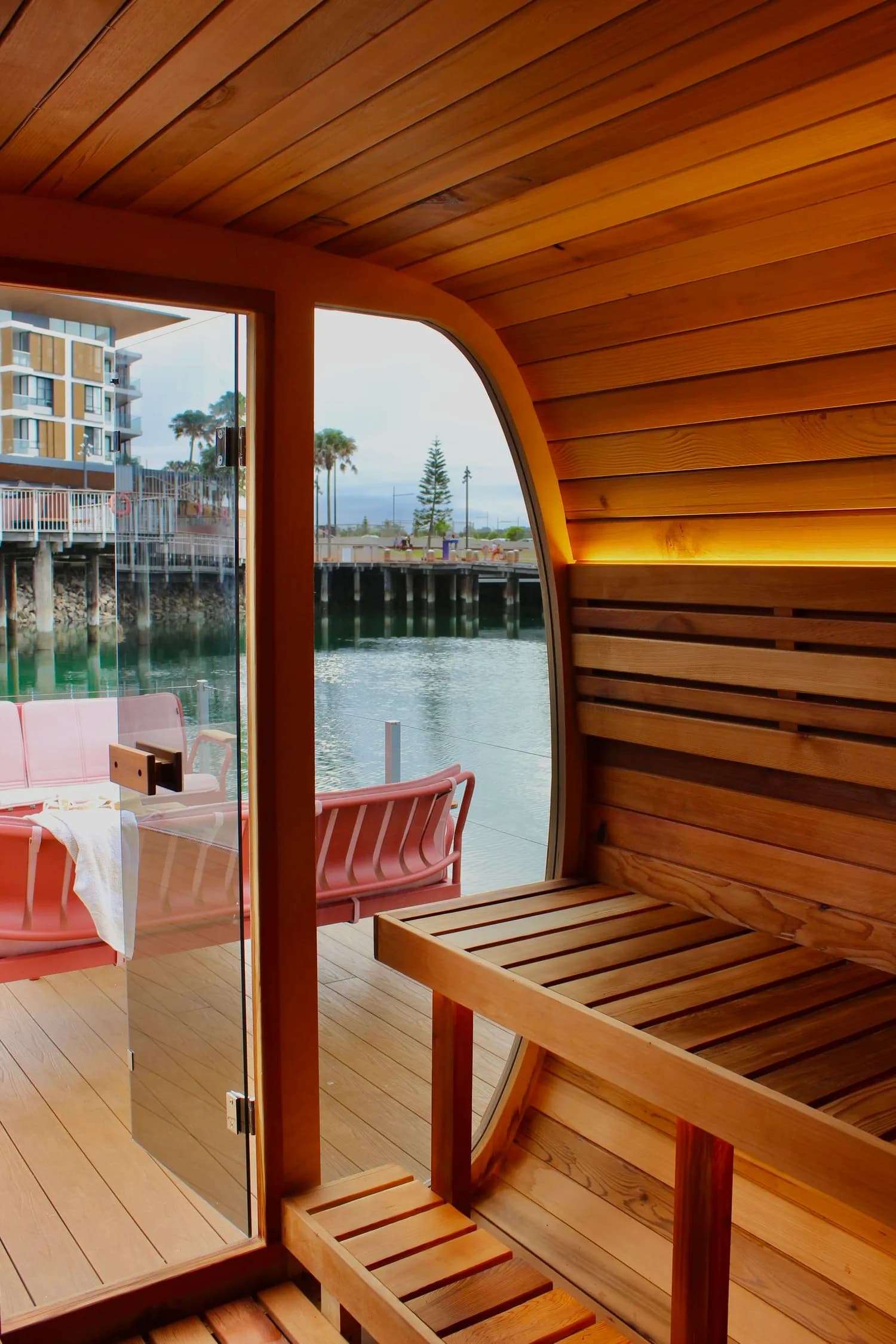 Those Floating Saunas interior with cedar benches and view of Shellharbour Marina