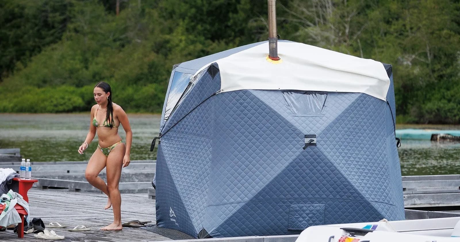 Triple Peak mobile tent sauna set up on a lakeside dock