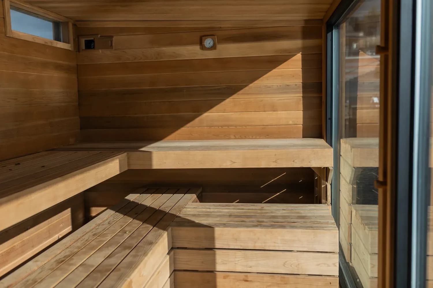 Von Sauna floating sauna interior with wooden benches seen through glass door