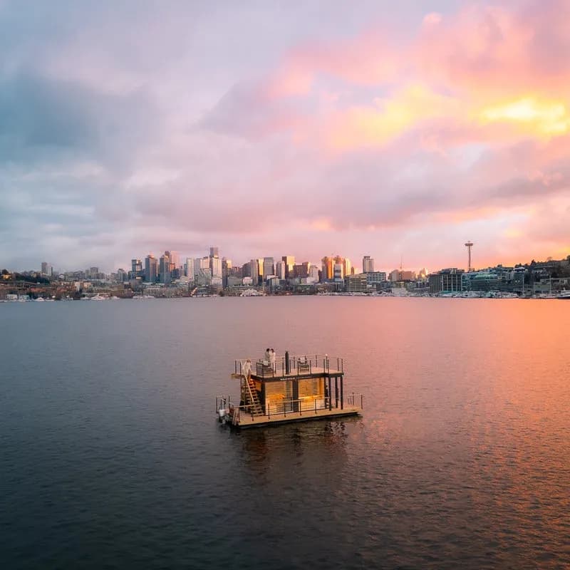 Wildhaus floating sauna on Lake Union at sunset with Seattle skyline