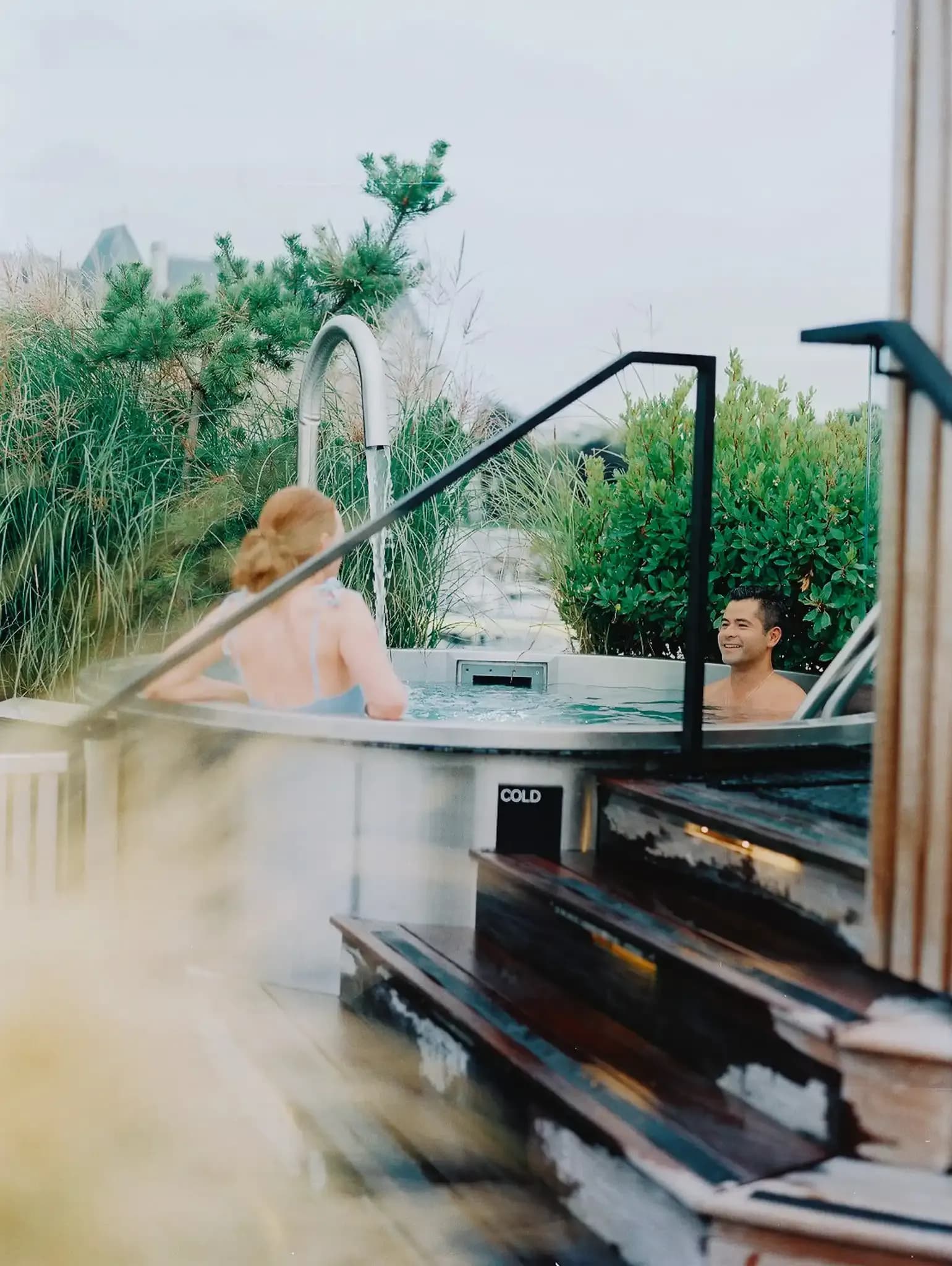 Guests in the cold plunge pool on HAVN's top deck surrounded by native plants