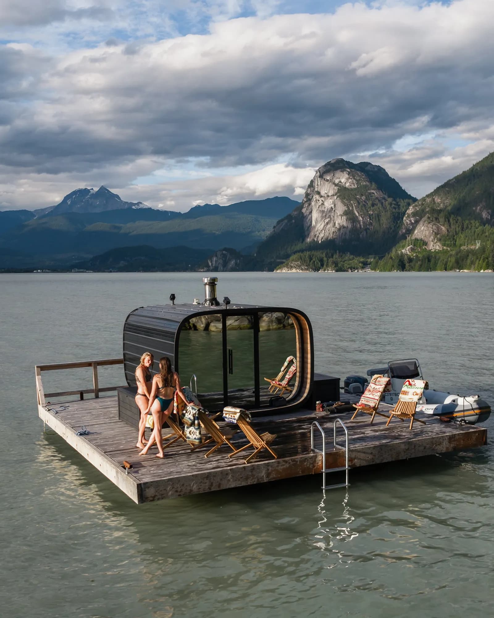 Aerial view of the InFlow floating sauna in Howe Sound with the Stawamus Chief in the background
